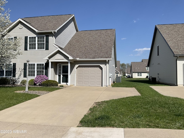 view of front of property featuring a garage, central AC, and a front lawn