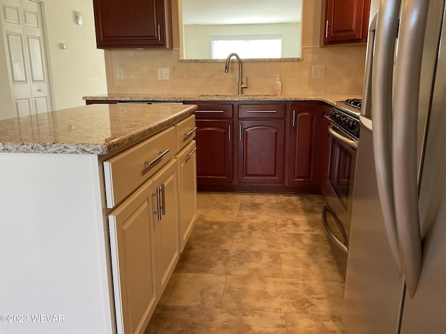 kitchen with backsplash, a center island, white fridge, and sink