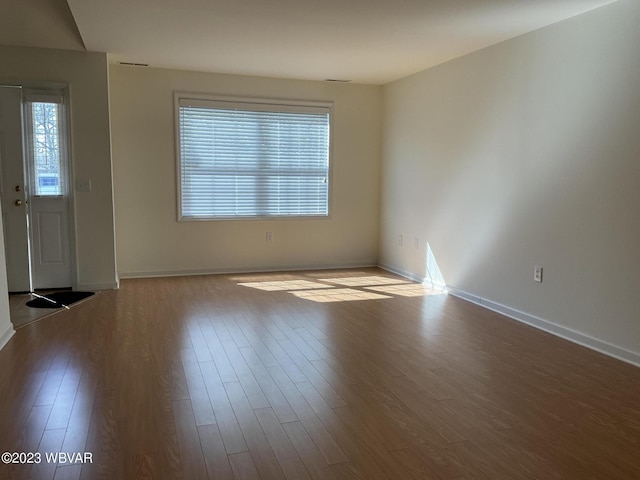 unfurnished room with light wood-type flooring