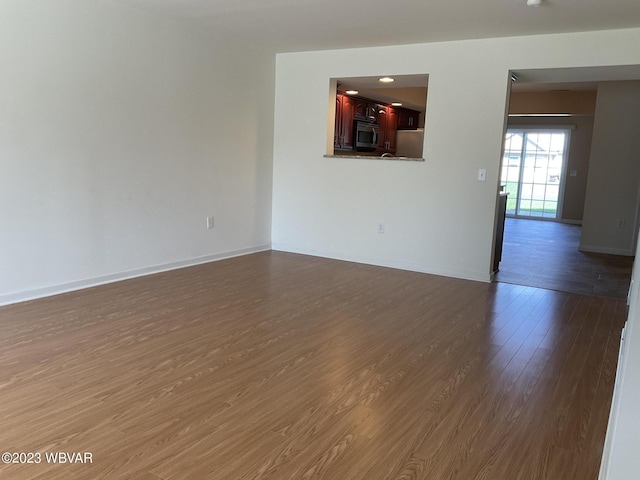 empty room featuring dark hardwood / wood-style flooring