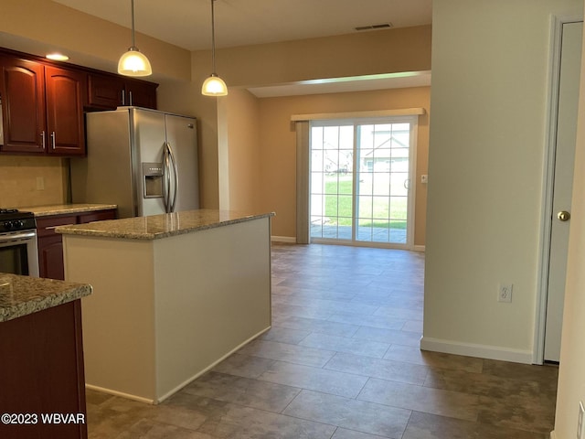 kitchen with decorative light fixtures, light stone counters, light tile patterned floors, and stainless steel appliances