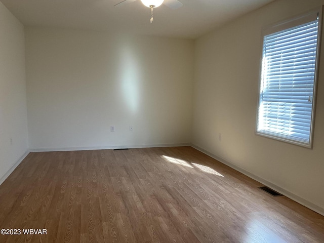 empty room featuring hardwood / wood-style flooring and ceiling fan