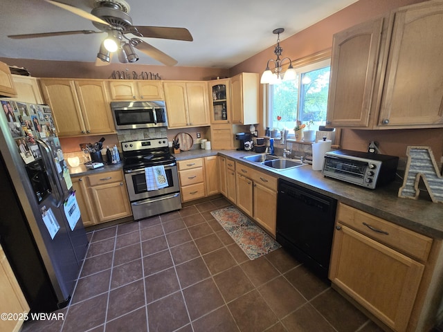 kitchen featuring stainless steel appliances, a sink, light brown cabinets, dark tile patterned floors, and a ceiling fan