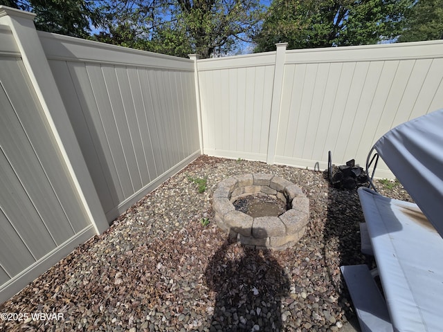 view of yard featuring fence and a fire pit