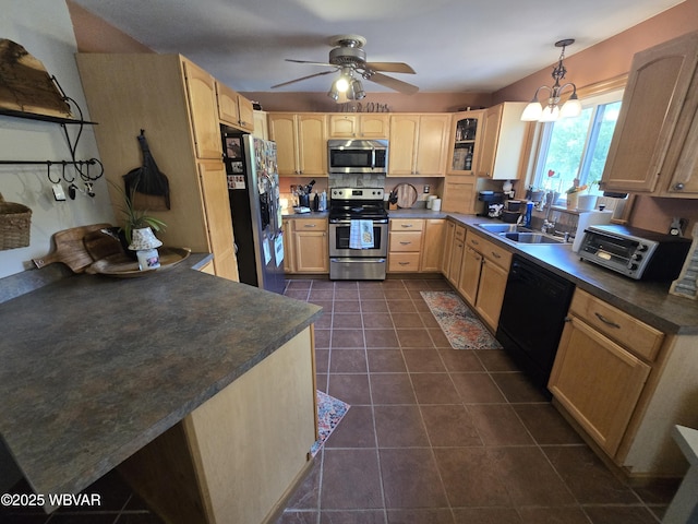 kitchen with stainless steel appliances, light brown cabinets, a sink, dark tile patterned floors, and dark countertops