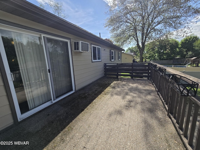 view of patio / terrace featuring a wall mounted AC and fence