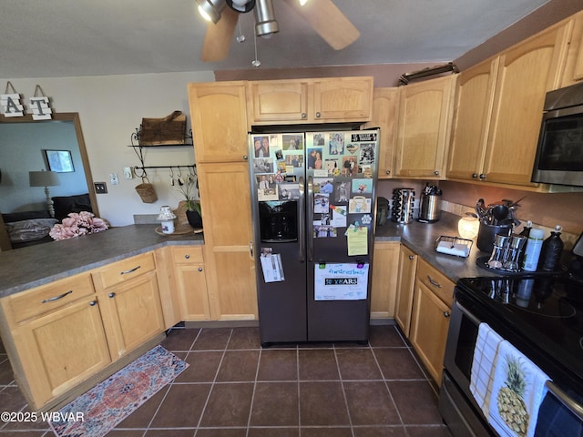 kitchen featuring stainless steel appliances, light brown cabinets, and a peninsula