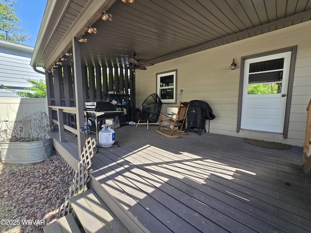 wooden terrace featuring a sunroom, area for grilling, and ceiling fan