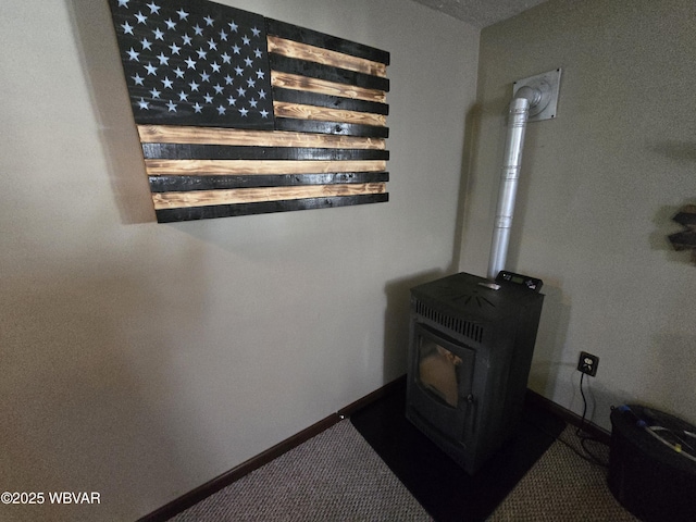 detailed view of a wood stove, carpet flooring, and baseboards