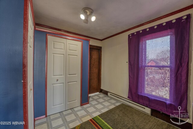 entryway with crown molding and baseboard heating