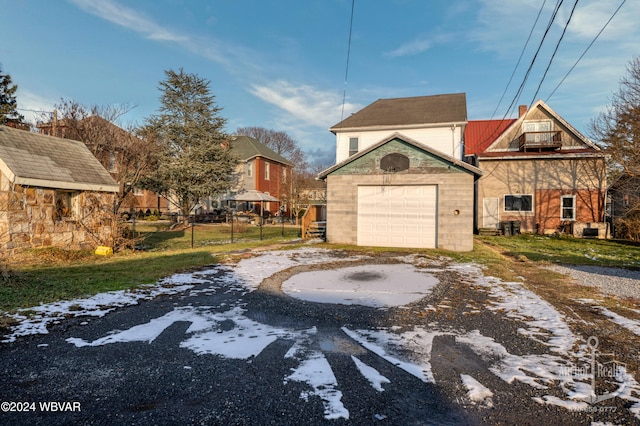 exterior space with a garage and an outbuilding