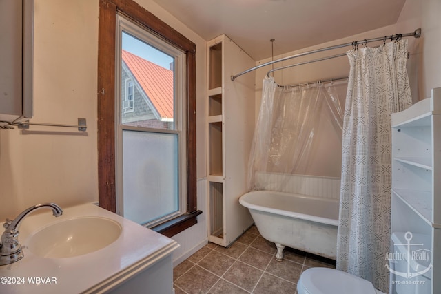 bathroom featuring tile patterned flooring, vanity, and toilet