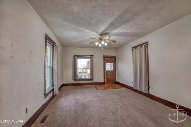 interior space with light colored carpet and ceiling fan