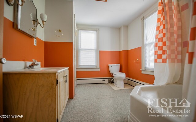 bathroom with vanity, a baseboard radiator, and a healthy amount of sunlight