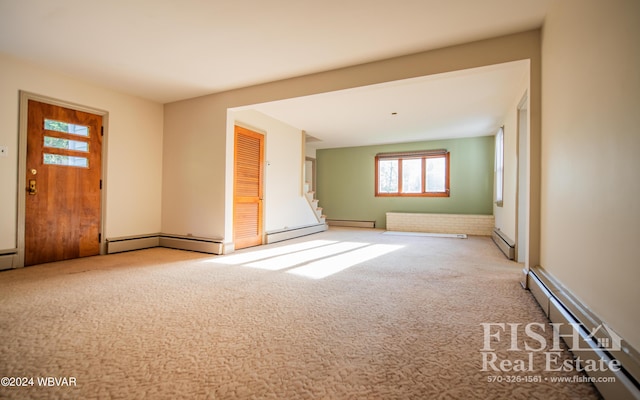 carpeted empty room with a baseboard heating unit