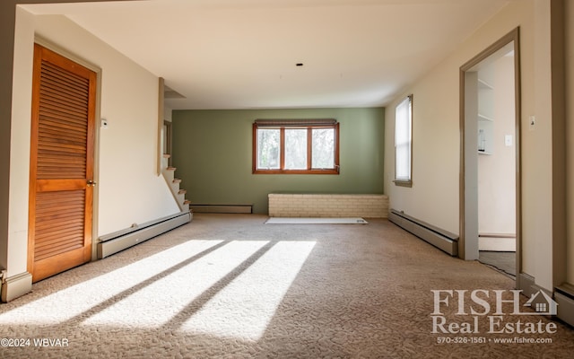 carpeted empty room with baseboard heating