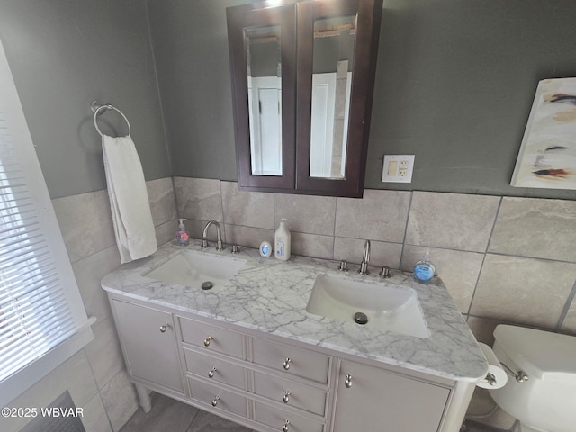 1206 Park Ave, Williamsport, PA 17701 - bathroom with double vanity, tile walls, toilet, and a sink