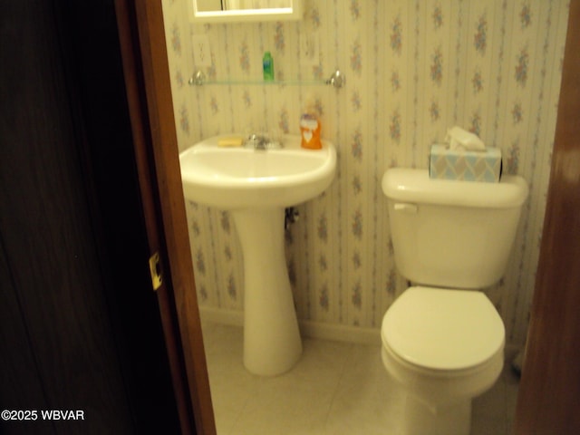 bathroom with toilet and tile patterned flooring