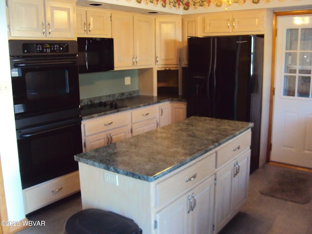 kitchen with white cabinetry, black appliances, and a kitchen island