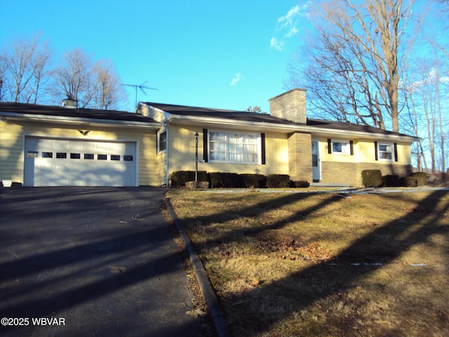 ranch-style house with a garage and a front yard