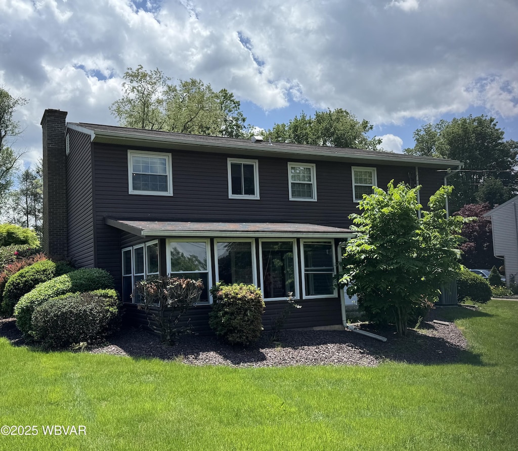 301 Charles Rd, Muncy, PA 17756 - view of front of home with a chimney, a sunroom, and a front lawn