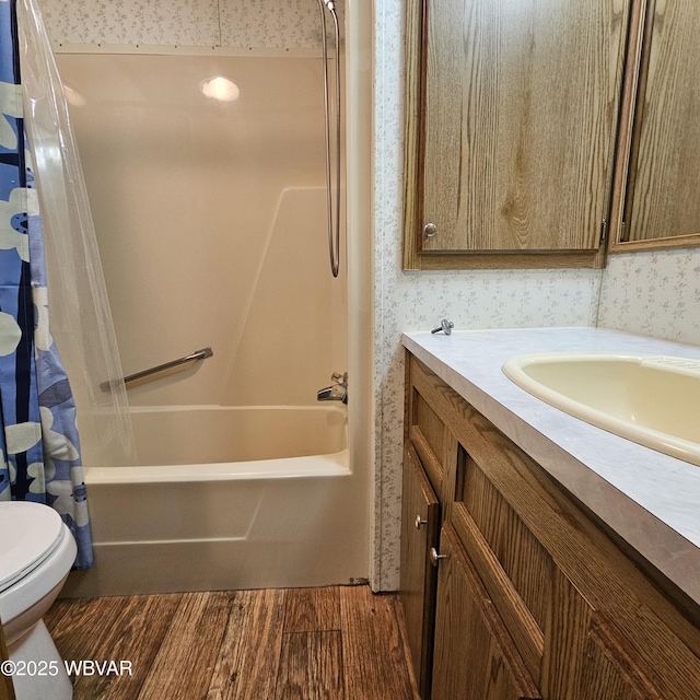 bathroom featuring shower / bath combination with curtain, wood finished floors, toilet, and wallpapered walls