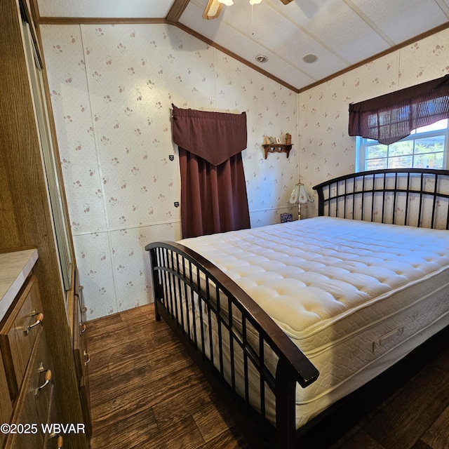 bedroom with vaulted ceiling, wood finished floors, and wallpapered walls