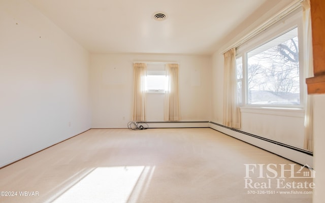 spare room with baseboard heating and carpet floors