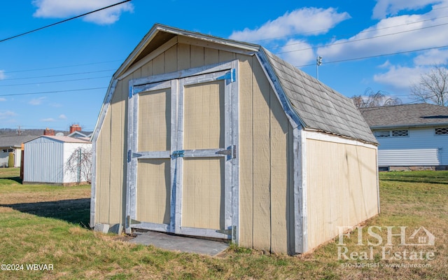 view of outdoor structure with a lawn