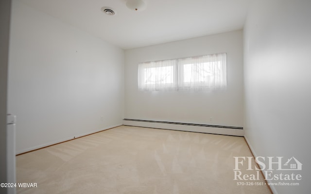 carpeted empty room with a baseboard radiator