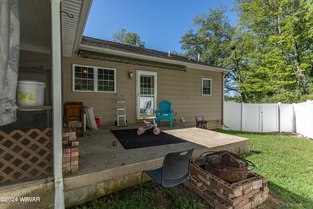 rear view of property featuring a patio area and a lawn