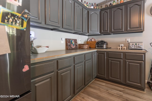 kitchen with stainless steel fridge and light wood-type flooring