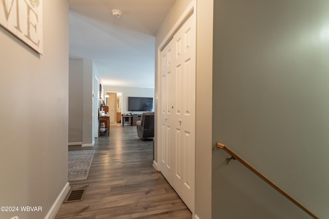 hallway with dark hardwood / wood-style floors