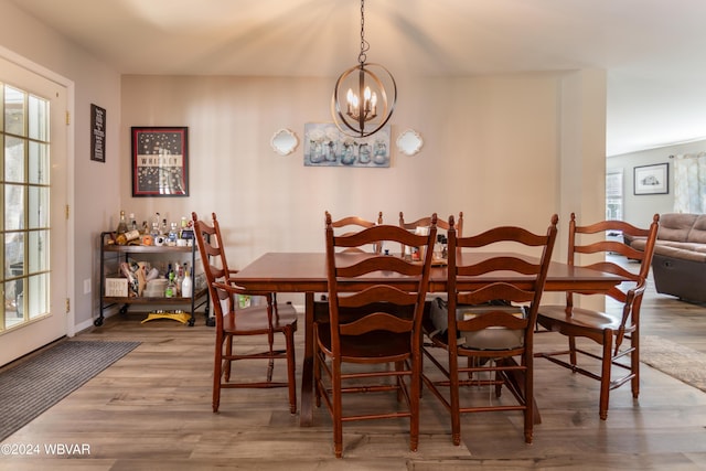 dining room featuring hardwood / wood-style flooring and an inviting chandelier