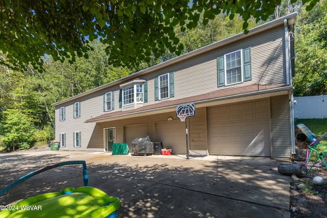 rear view of property with a garage