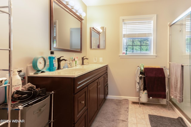 bathroom featuring tile patterned floors, vanity, and a shower with shower door