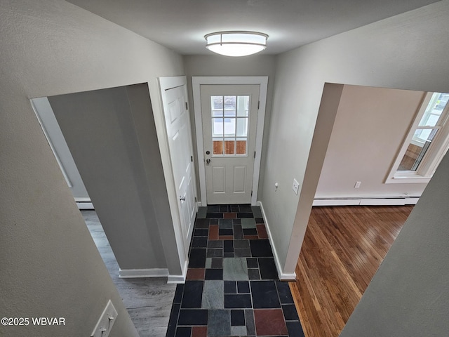 doorway to outside with baseboards, a baseboard radiator, a baseboard heating unit, and wood finished floors