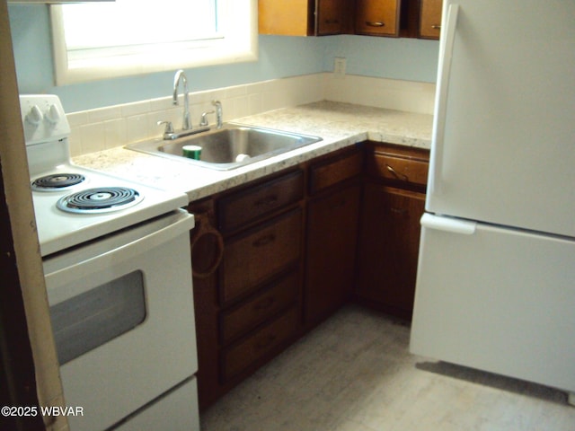 117 Oak Ln, Lock Haven, PA 17745 - kitchen featuring white appliances, light countertops, and brown cabinetry
