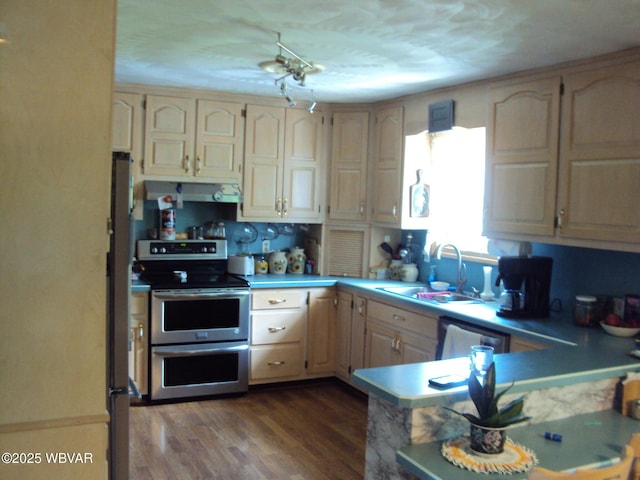 117 Oak Ln, Lock Haven, PA 17745 - kitchen with appliances with stainless steel finishes, range hood, light countertops, dark wood-style floors, and a peninsula