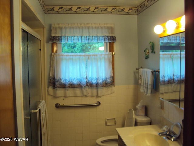 117 Oak Ln, Lock Haven, PA 17745 - bathroom with tile walls, a stall shower, vanity, and a wainscoted wall