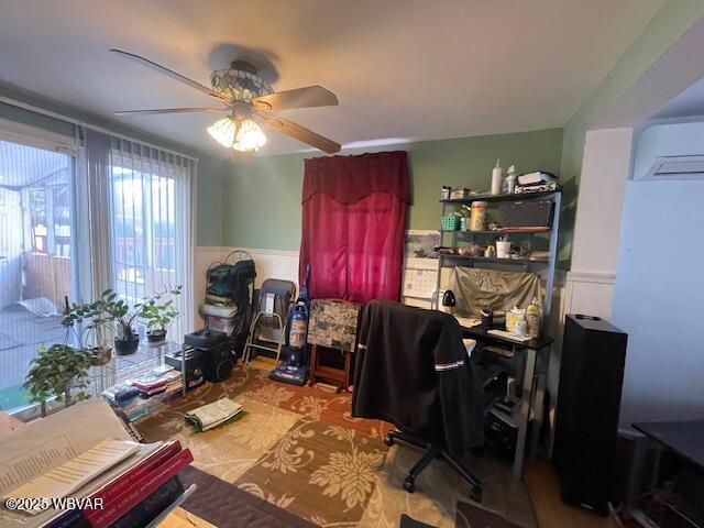 office featuring an AC wall unit and ceiling fan