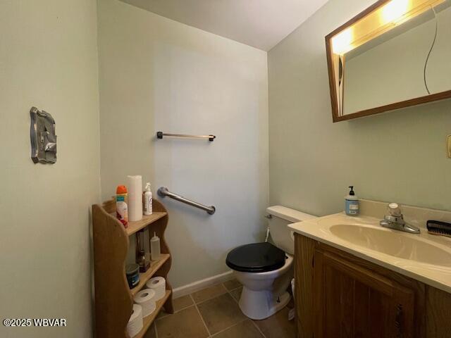 bathroom with tile patterned floors, vanity, and toilet