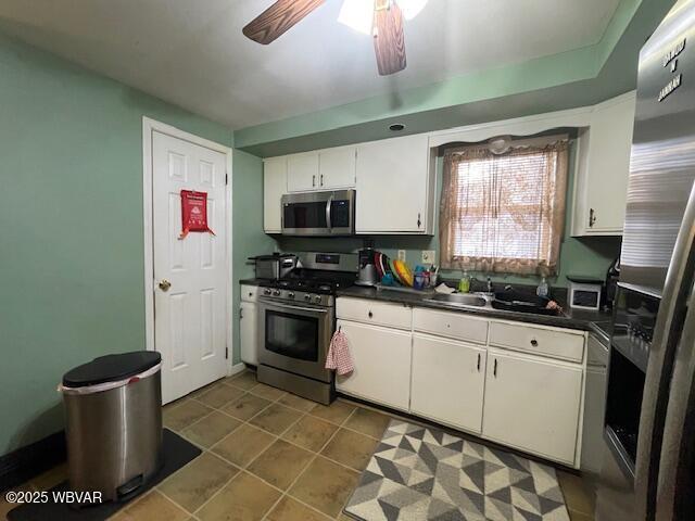 kitchen with ceiling fan, white cabinets, and appliances with stainless steel finishes