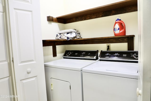 clothes washing area with washing machine and dryer