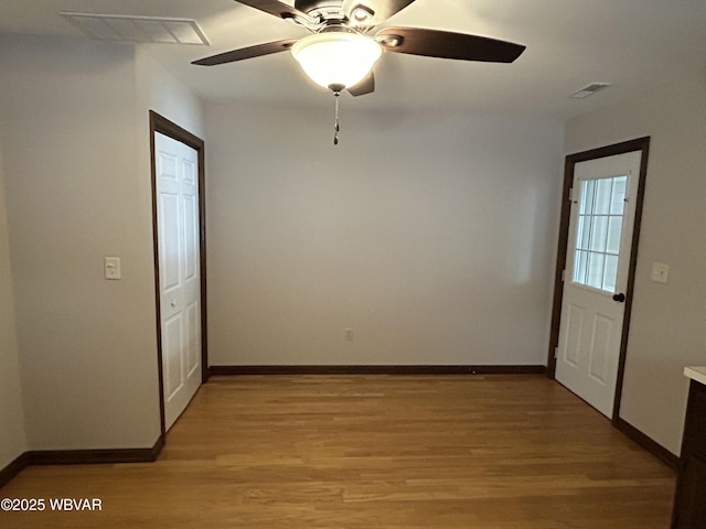 empty room featuring ceiling fan and light hardwood / wood-style floors