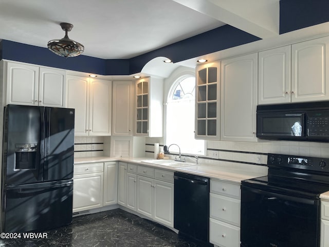 kitchen featuring black appliances, sink, white cabinetry, and backsplash