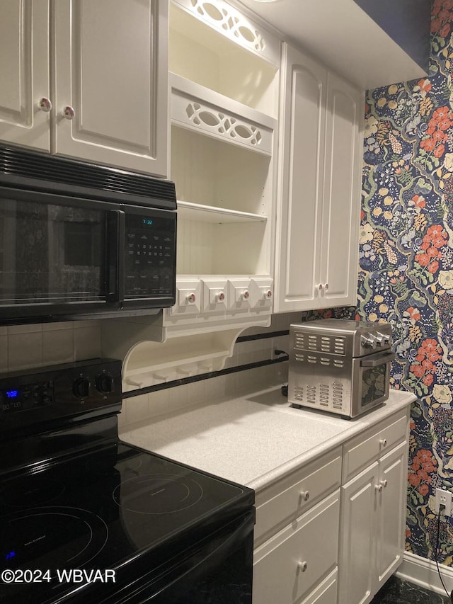 kitchen with white cabinets and black appliances