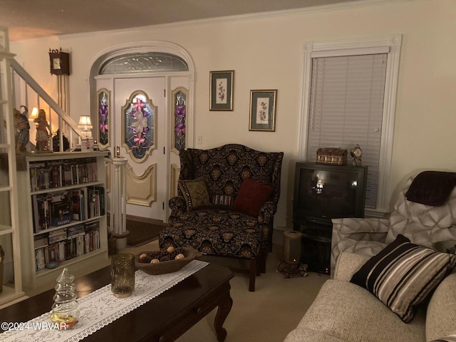 sitting room featuring crown molding and carpet floors