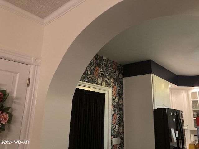 details featuring black fridge and crown molding