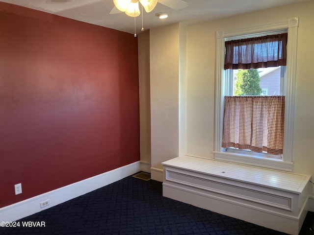 interior space with ceiling fan